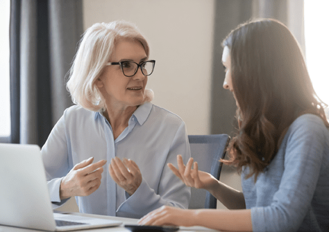 Two women consulting with a laptop