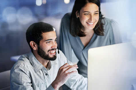 Two people smiling while watching automated PDF remediation with Eqiudox AI