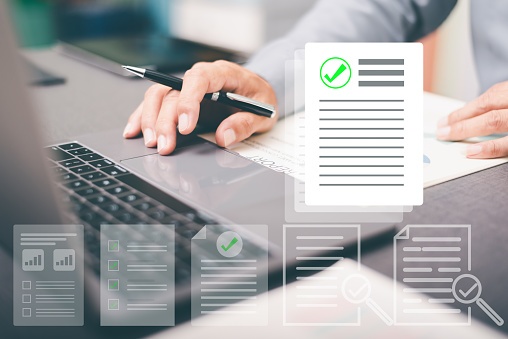 Concept image of virtual documents above a laptop, indicating PDF remediation software.