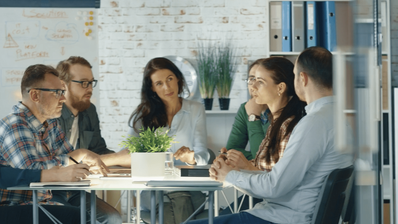 Team working around a laptop.