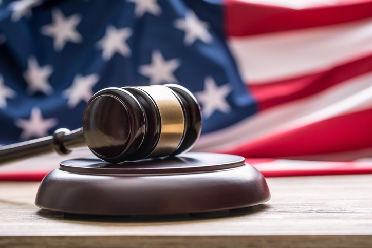 Gavel in front of an American flag representing Texas law